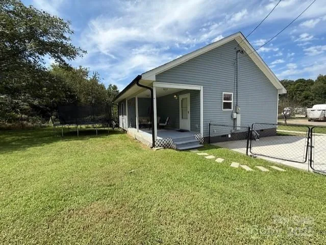 a backyard of a house with table and chairs