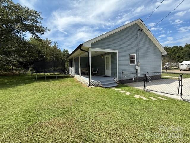 114 Yates Street Dallas, NC 28034 - Photo 10 of 41 a backyard of a house with table and chairs