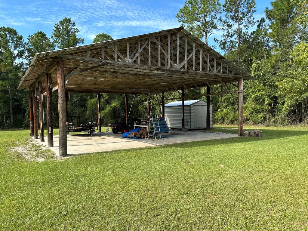 2707 Jane Lane Hilliard, FL 32046 - Photo 18 of 26 a view of a house with a backyard and a patio