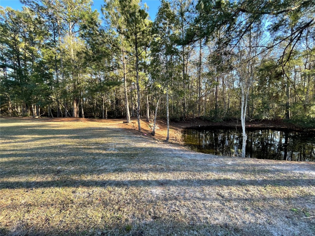 2707 Jane Lane Hilliard, FL 32046 - Photo 23 of 26 a view of a swimming pool with a bench