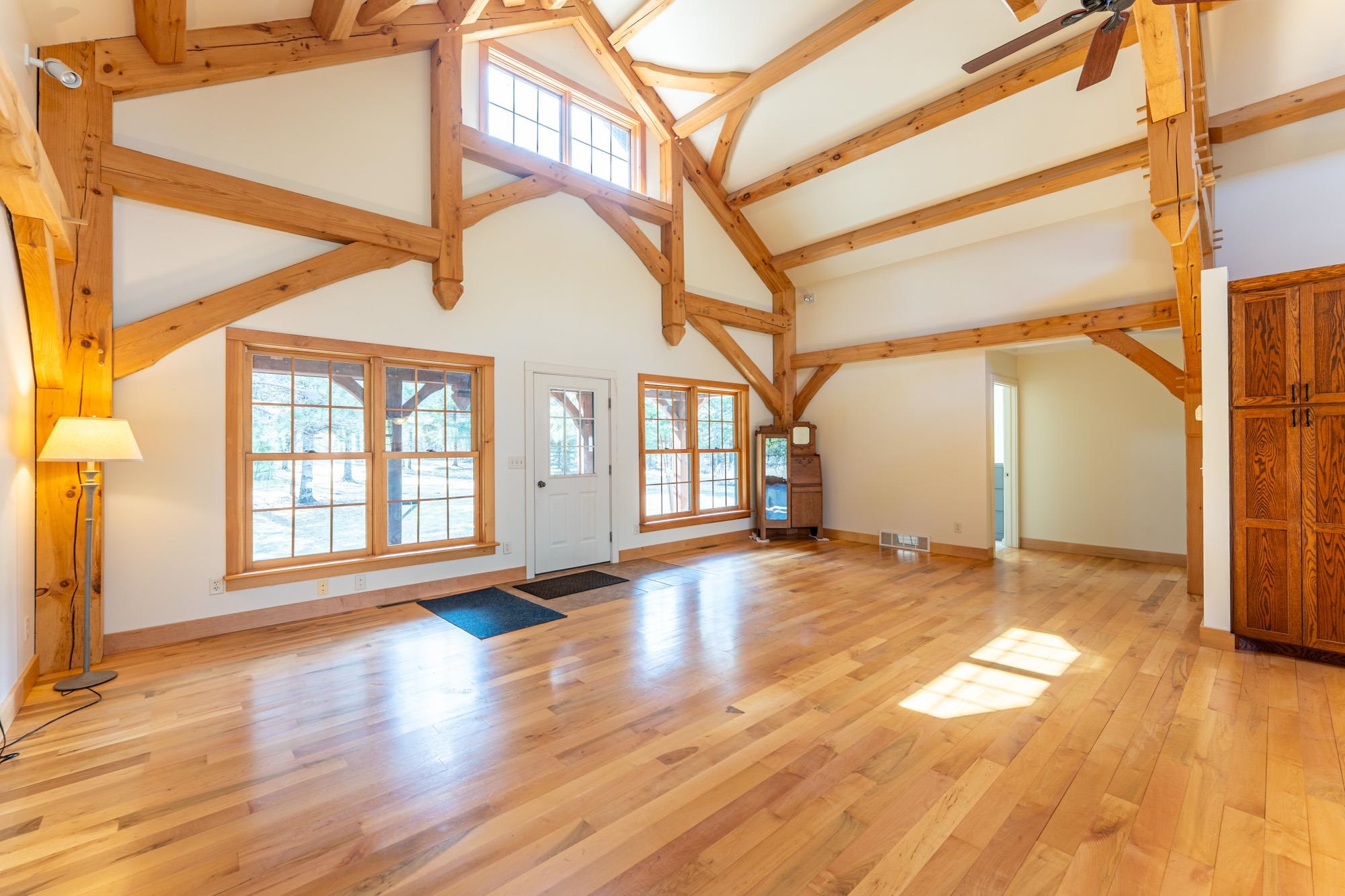 2263 Longstorff Road Ely, MN 55731 - Photo 9 of 49 Interior space featuring visible vents, beam ceiling, high vaulted ceiling, baseboards, and light wood finished floors