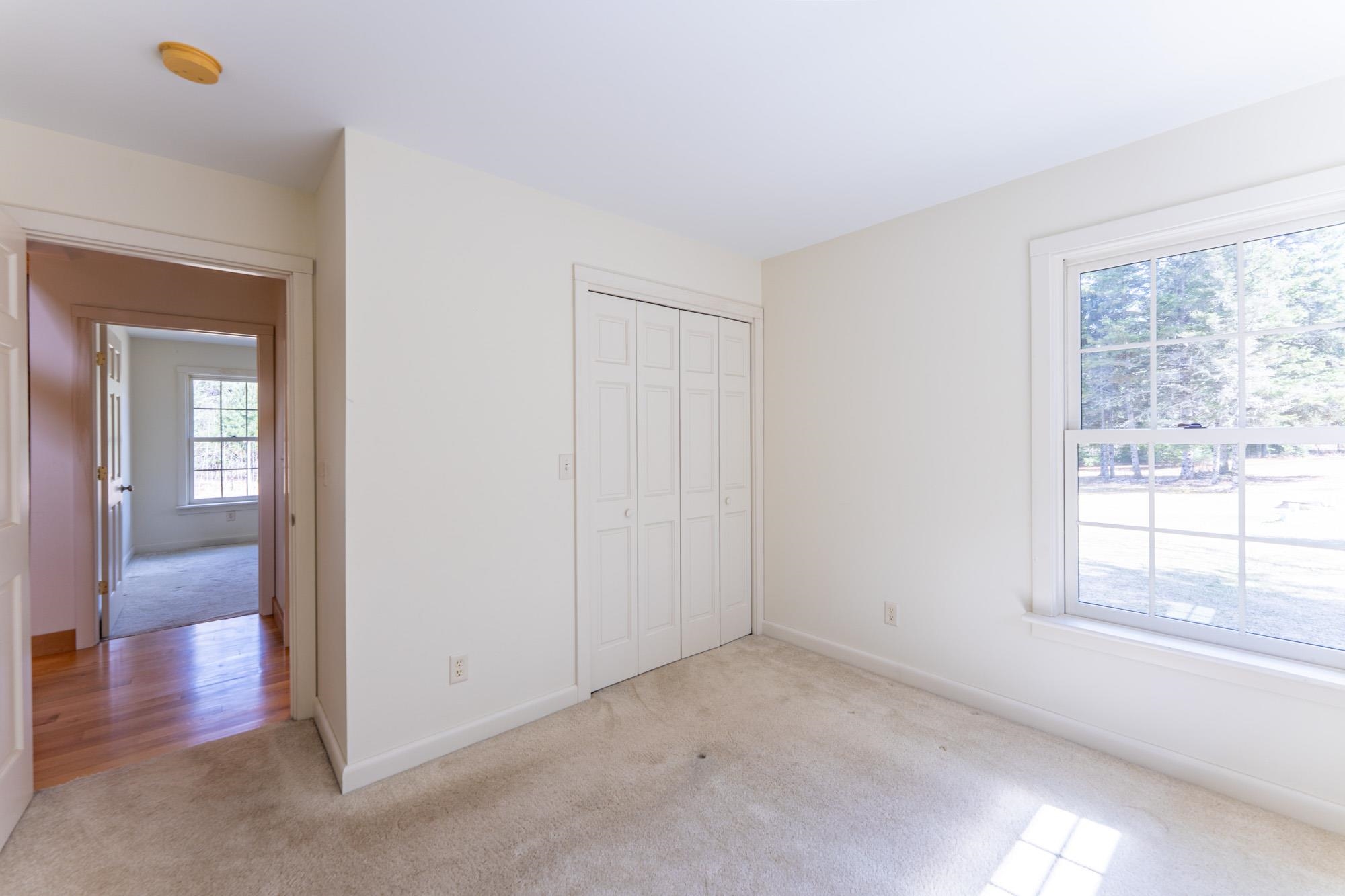 2263 Longstorff Road Ely, MN 55731 - Photo 15 of 49 Unfurnished bedroom featuring baseboards, a closet, and light colored carpet