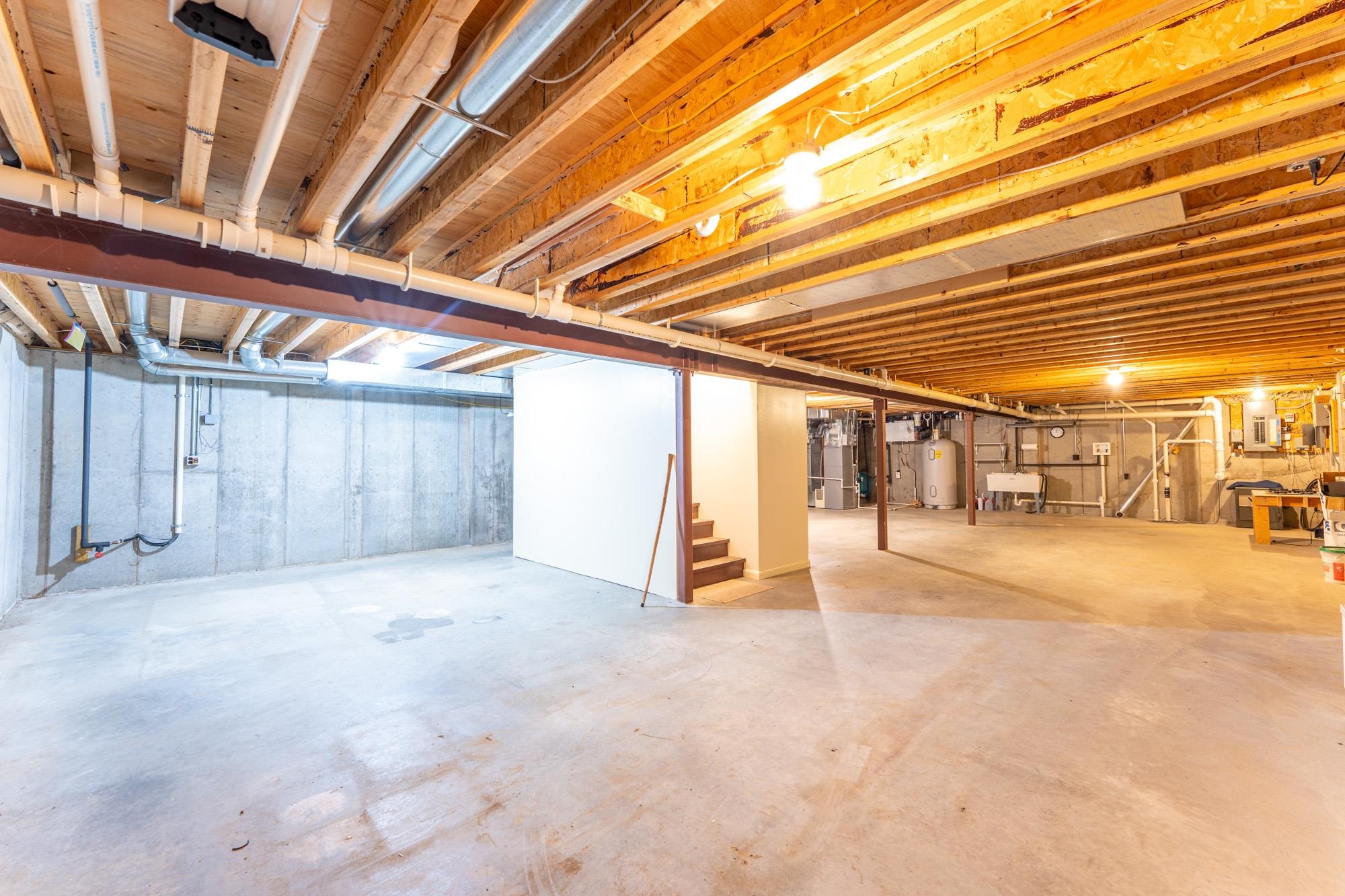 2263 Longstorff Road Ely, MN 55731 - Photo 18 of 49 Unfinished basement with stairway, gas water heater, and a sink