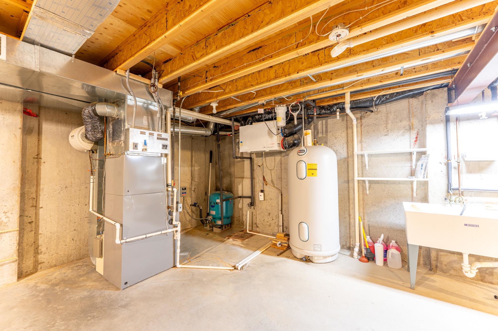 2263 Longstorff Road Ely, MN 55731 - Photo 21 of 49 Unfinished basement featuring a sink, heating unit, and water heater
