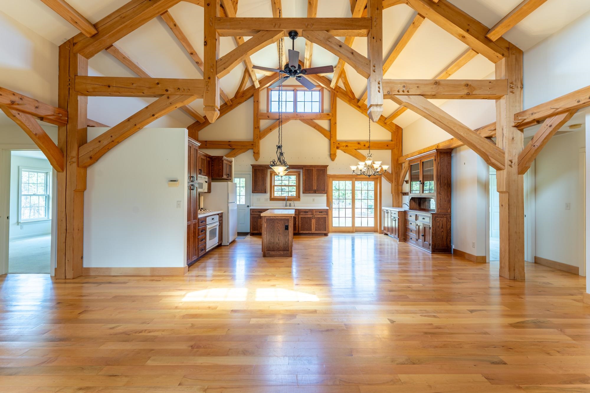 2263 Longstorff Road Ely, MN 55731 - Photo 5 of 49 Great Room featuring timber frame beamed ceiling, high vaulted ceiling, and a healthy amount of sunlight