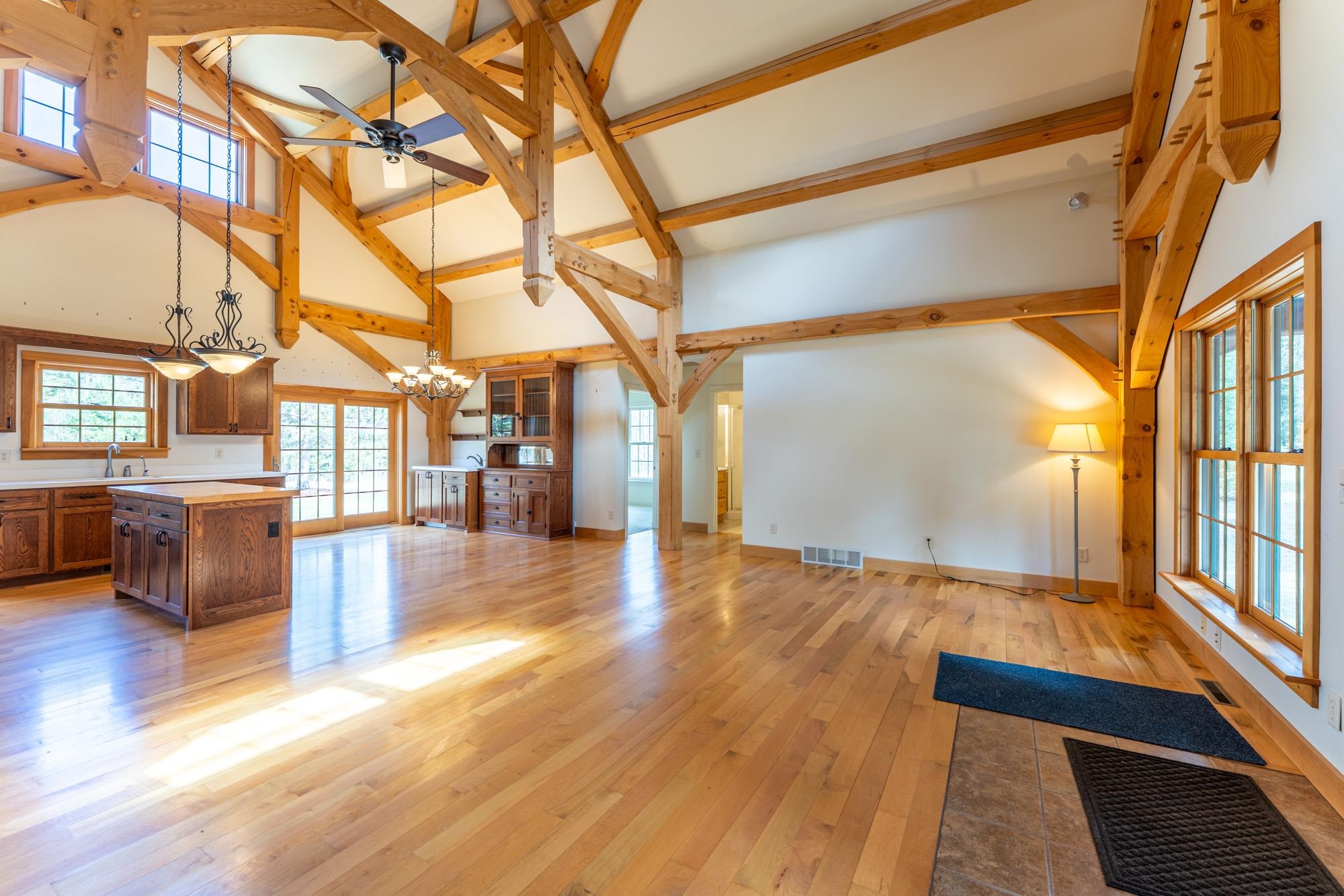 2263 Longstorff Road Ely, MN 55731 - Photo 6 of 49 Unfurnished living room with visible vents, beamed ceiling, high vaulted ceiling, a sink, and ceiling fan with notable chandelier