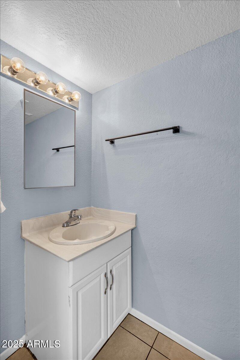 2437 East Tracy Lane, Unit 2 Phoenix, AZ 85032 - Photo 12 of 30 a bathroom with a sink and a mirror