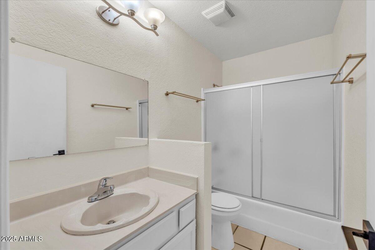 2437 East Tracy Lane, Unit 2 Phoenix, AZ 85032 - Photo 14 of 30 a bathroom with a sink toilet and a mirror