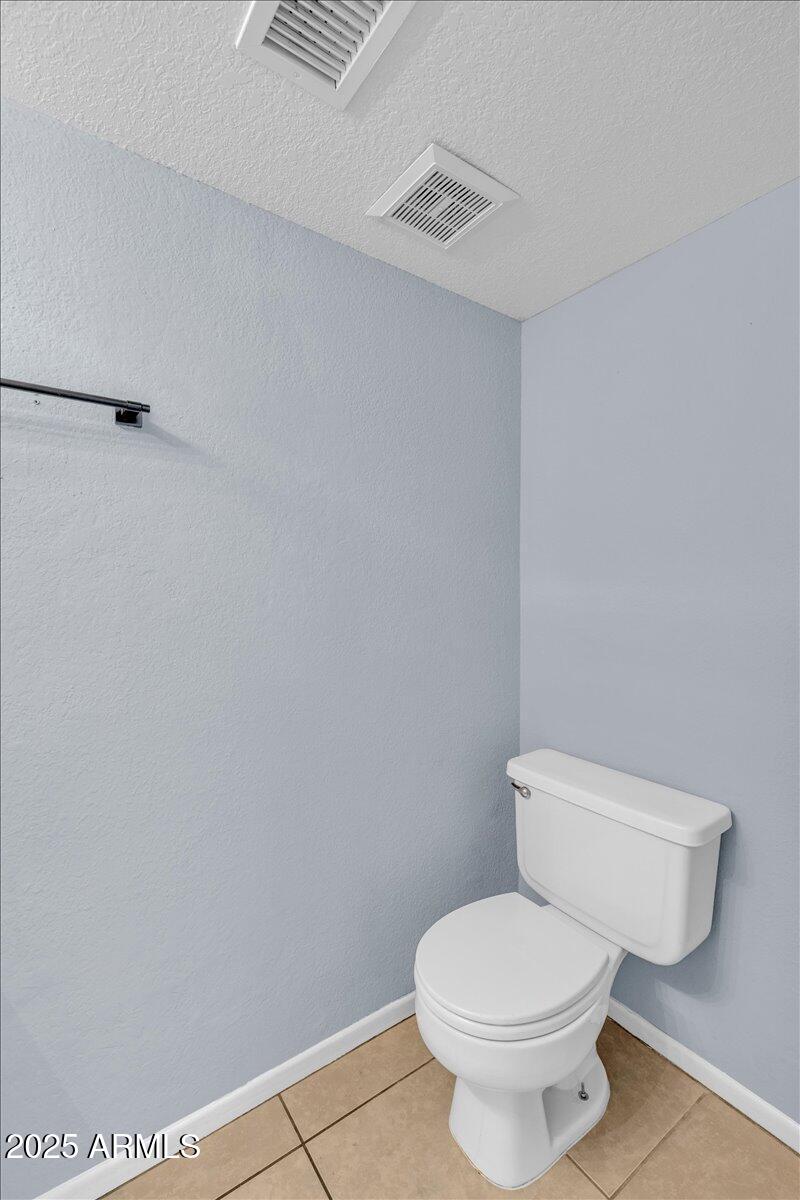 2437 East Tracy Lane, Unit 2 Phoenix, AZ 85032 - Photo 19 of 30 a white toilet sitting next to a white wall