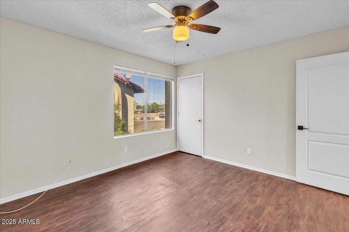 2437 East Tracy Lane, Unit 2 Phoenix, AZ 85032 - Photo 20 of 30 a view of an empty room with window and wooden floor