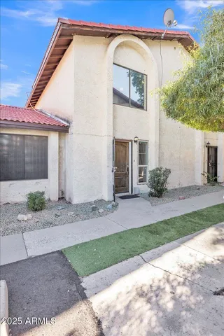 a view of a house with a yard and plants