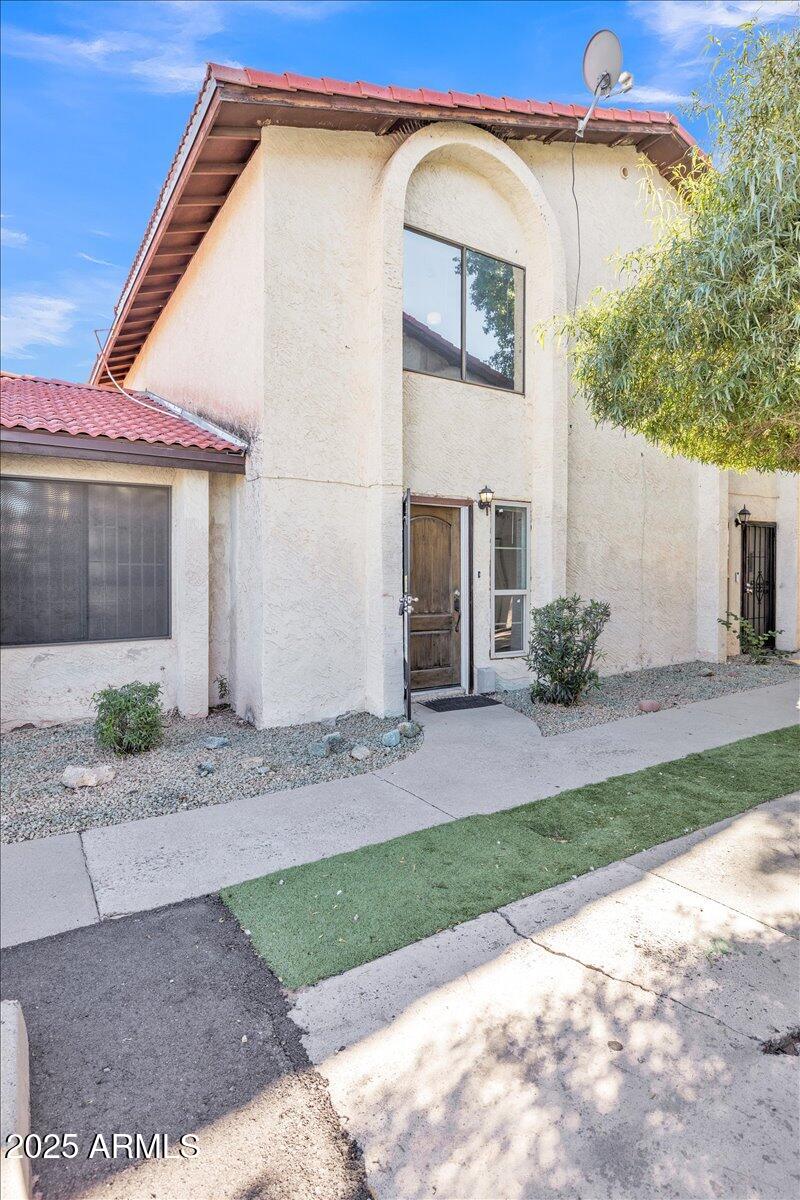 2437 East Tracy Lane, Unit 2 Phoenix, AZ 85032 - Photo 2 of 30 a view of a house with a yard and plants