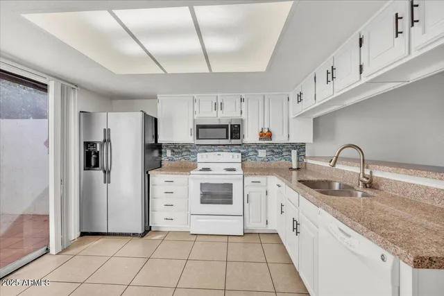 an empty room with a window and a ceiling fan