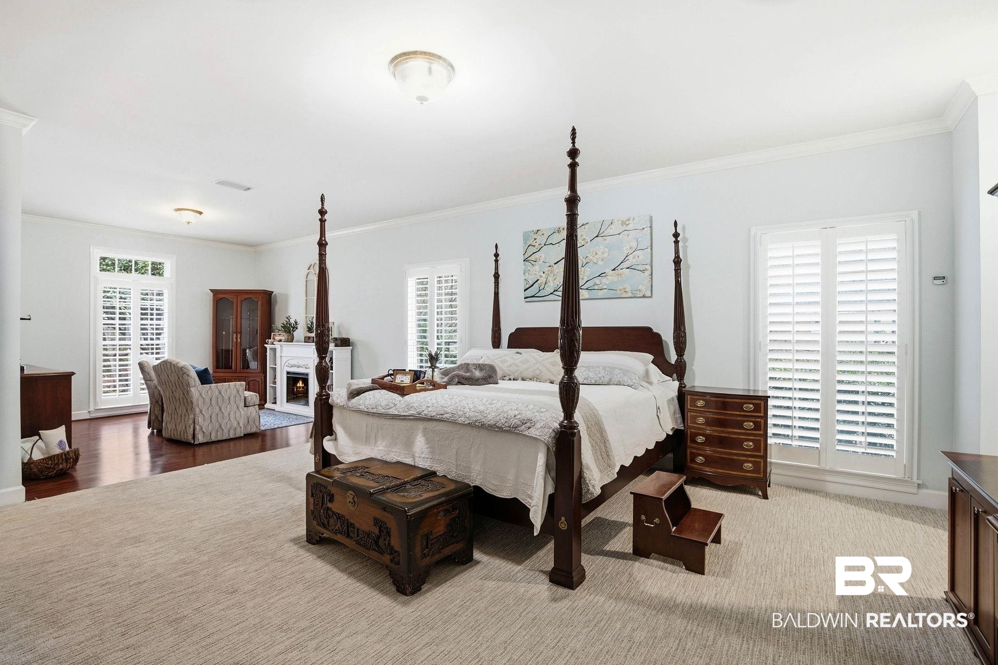31515 Rhett Drive Spanish Fort, AL 36527 - Photo 31 of 100 The oversize primary suite has TWO walk in closets, a coat closet, a sitting area with an electric fireplace, crown molding, a large linen closet, and plantation shutters. The primary suite measures 16' 2" x 34' 6"