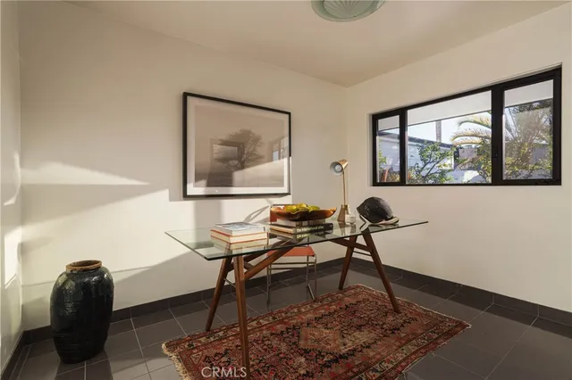a work room with furniture and a potted plant