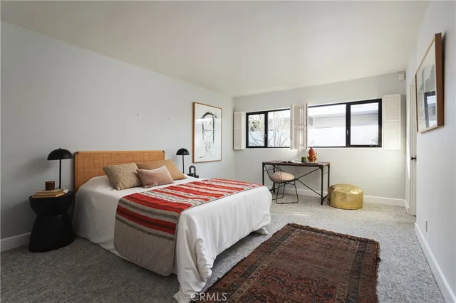 a bedroom with bed and window