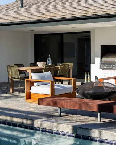 a kitchen with kitchen island stainless steel appliances and living room view