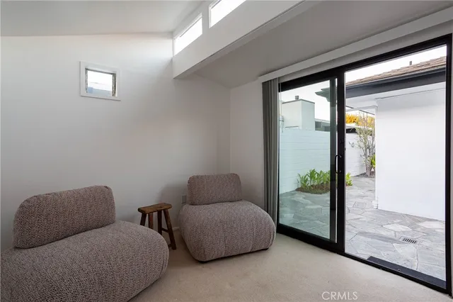 a living room with furniture and a glass door