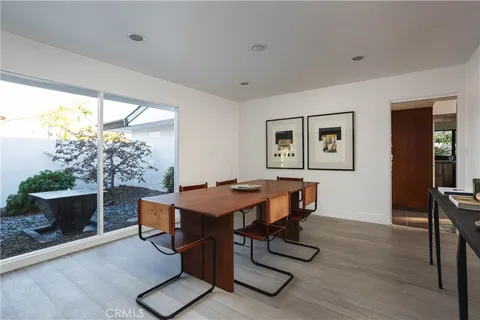 a view of a dining room with furniture and window