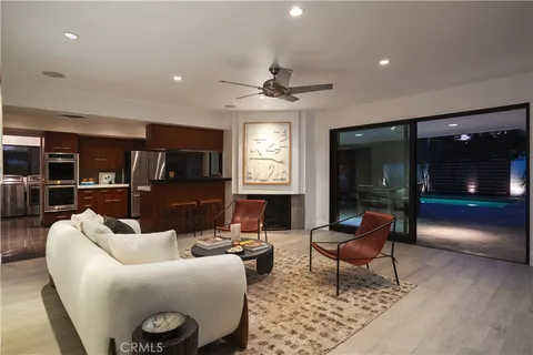 a living room with furniture a lamp and a window