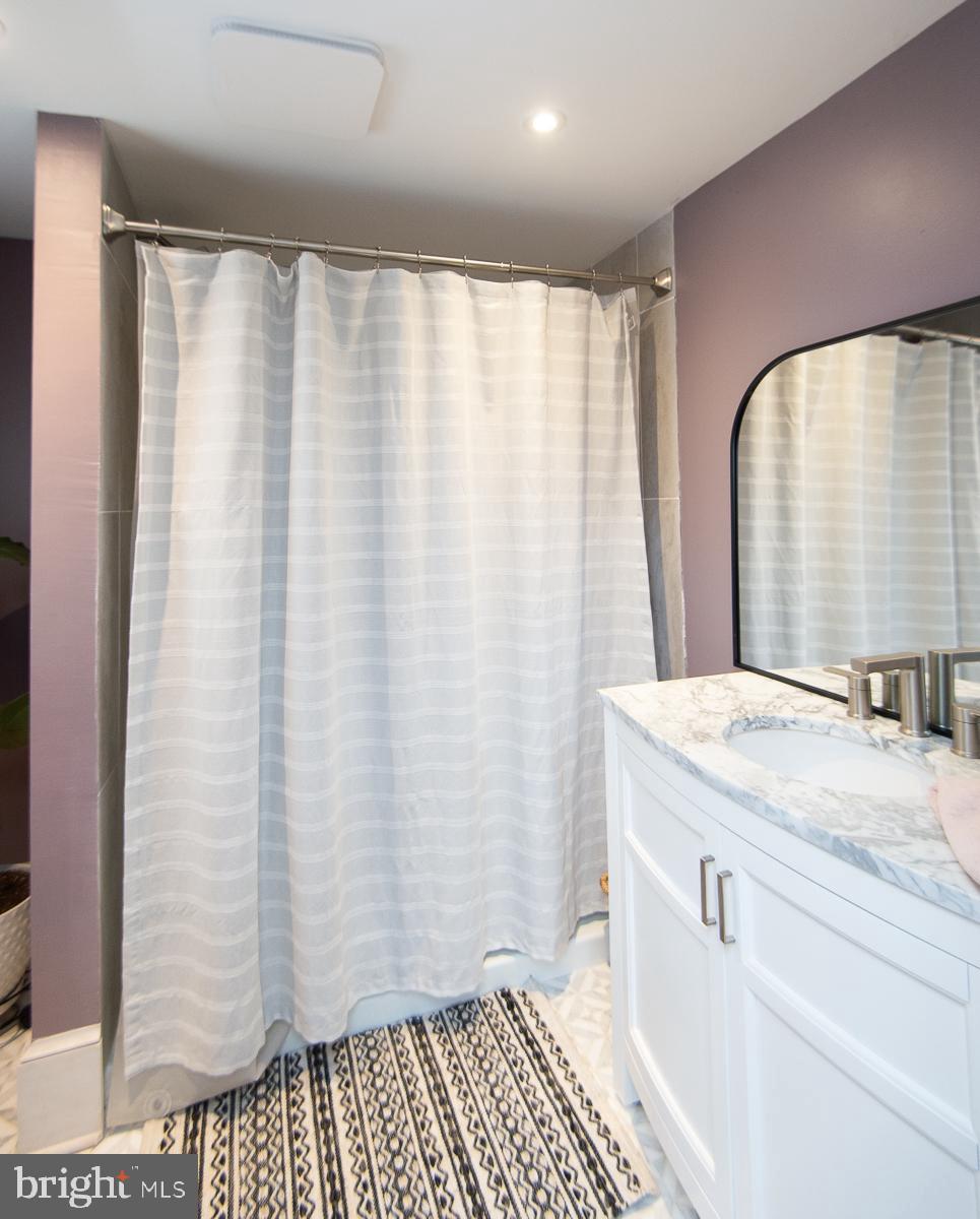 3755 Sunnyside Road East New Market, MD 21631 - Photo 16 of 37 a bathroom with a granite countertop sink and a mirror
