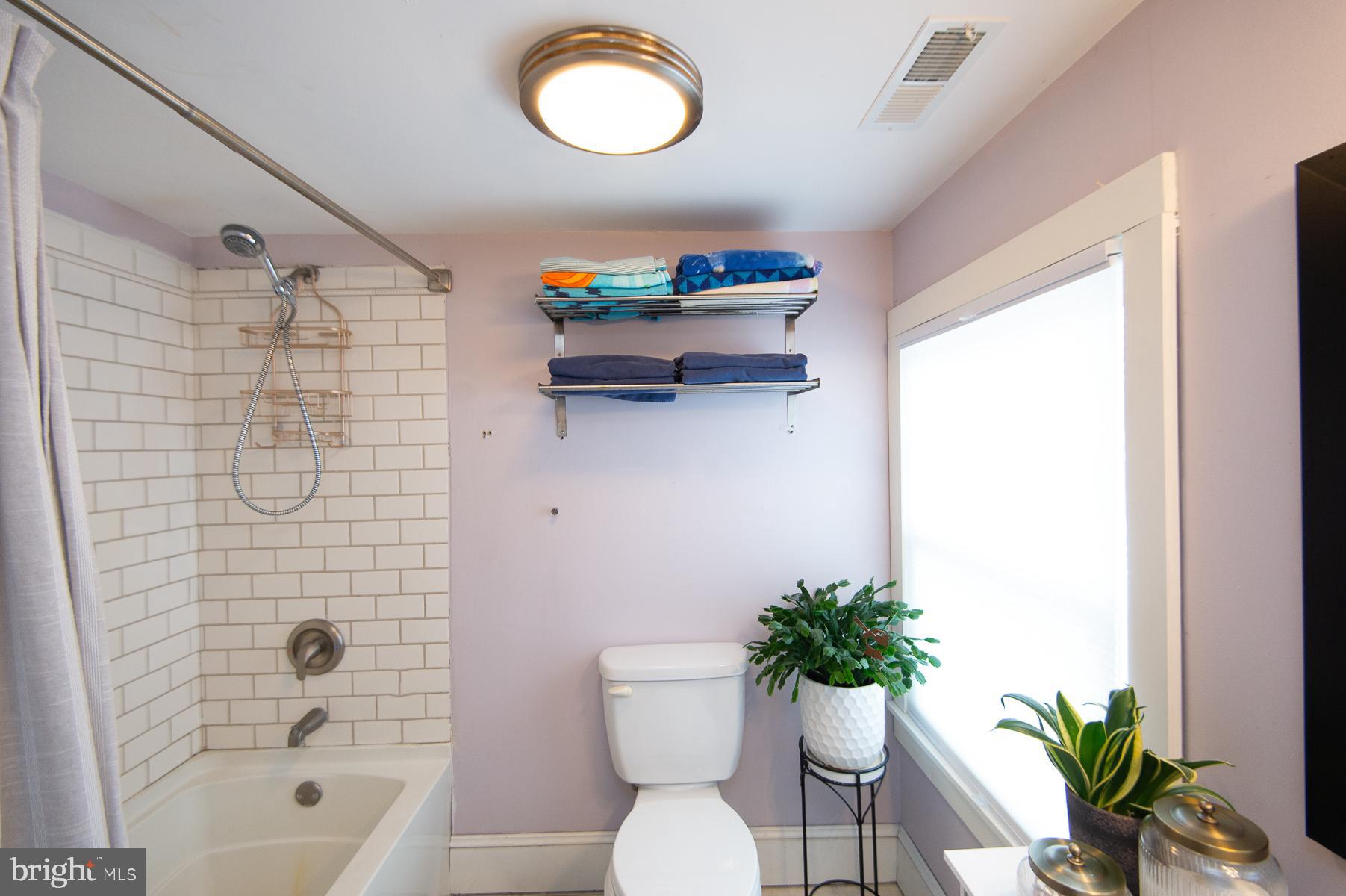 3755 Sunnyside Road East New Market, MD 21631 - Photo 27 of 37 a bathroom with a shower curtain and a toilet