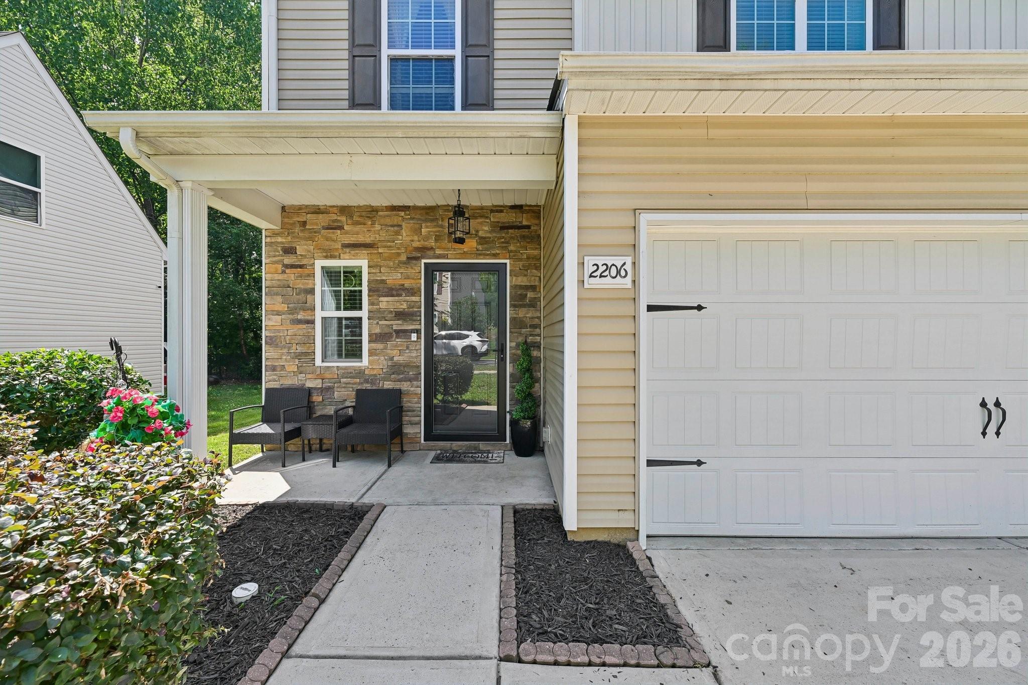 2206 Turtle Point Road Charlotte, NC 28262 - Photo 2 of 28 a front view of a house with a garden