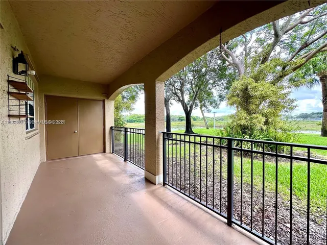 a view of a porch with wooden floor and outdoor space