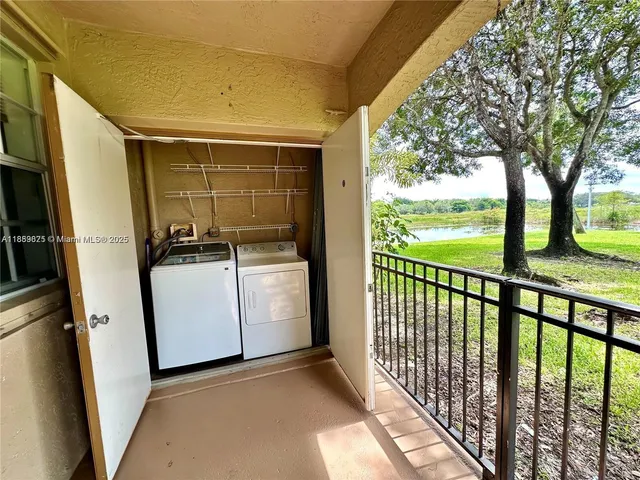 a view of a chandelier fan and refrigerator in a room