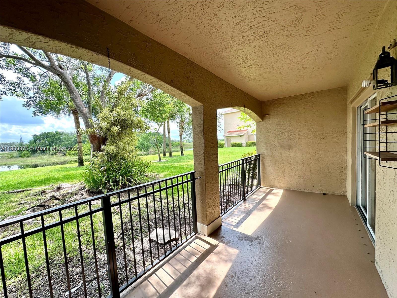 231 Southwest 116th Avenue, Unit 19108 Pembroke Pines, FL 33025 - Photo 16 of 56 a view of a porch with wooden floor and outdoor space