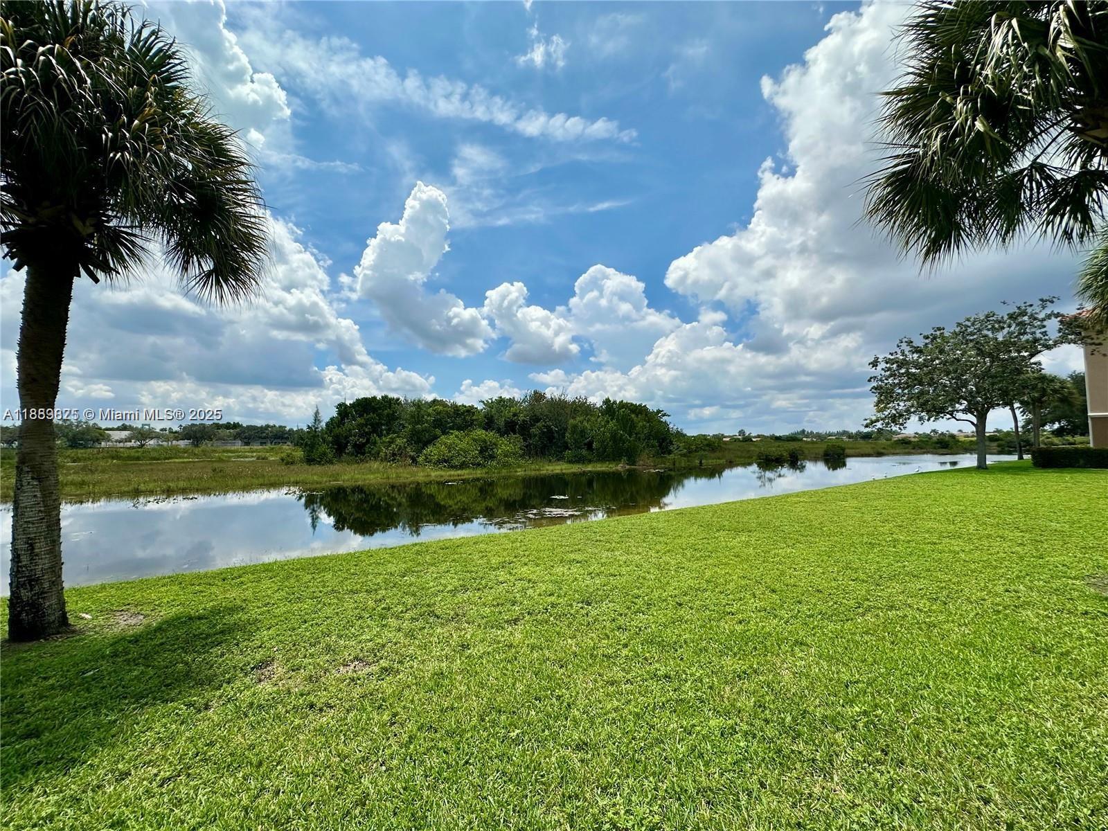 231 Southwest 116th Avenue, Unit 19108 Pembroke Pines, FL 33025 - Photo 18 of 56 a view of lake with houses in the back