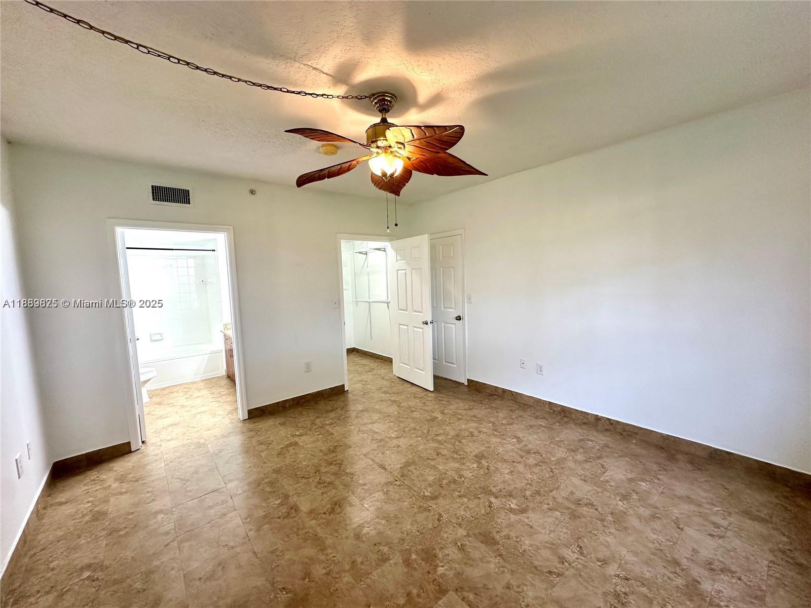 231 Southwest 116th Avenue, Unit 19108 Pembroke Pines, FL 33025 - Photo 19 of 56 a view of a chandelier fan and refrigerator in a room
