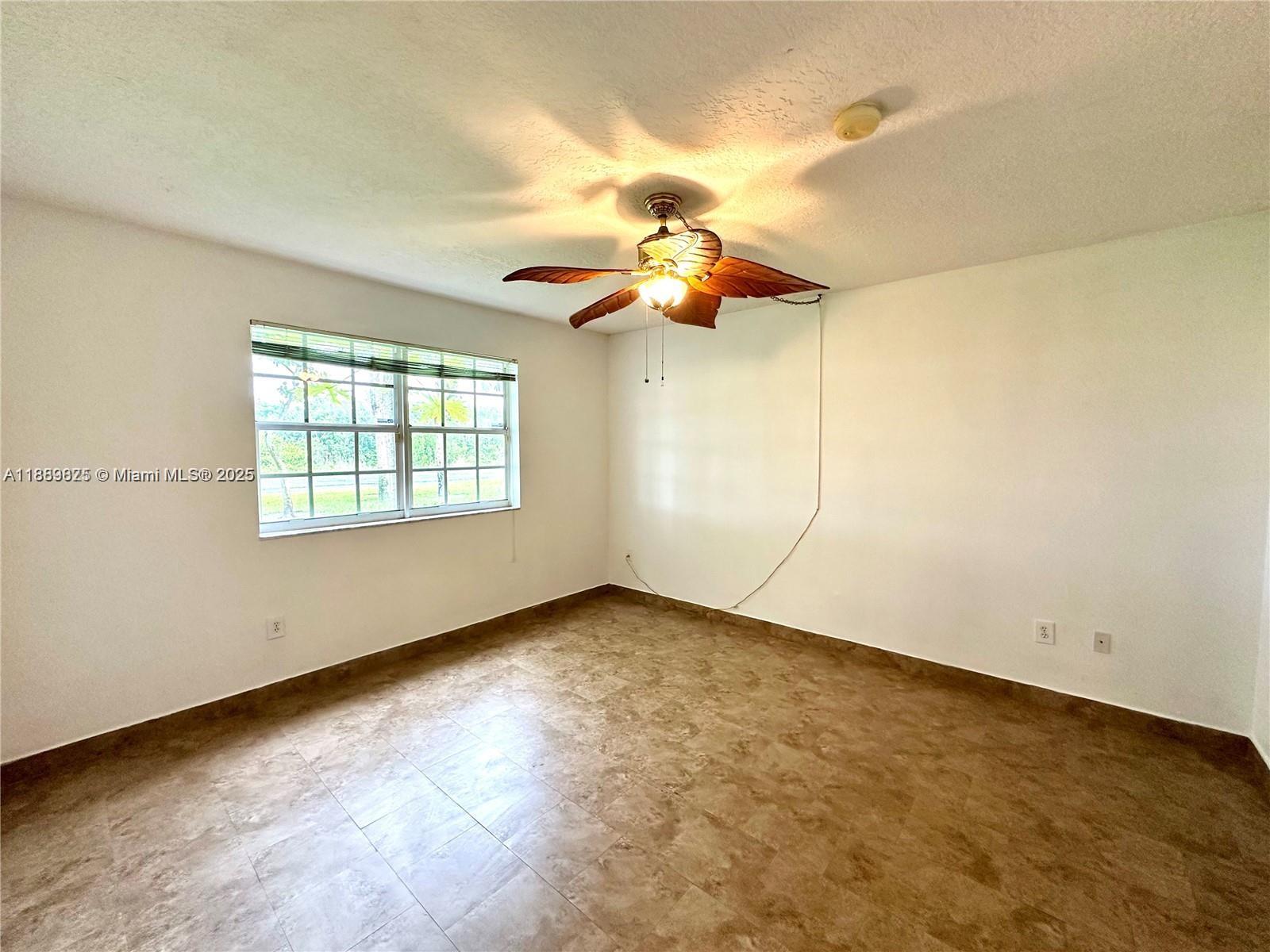 231 Southwest 116th Avenue, Unit 19108 Pembroke Pines, FL 33025 - Photo 22 of 56 an empty room with windows and fan