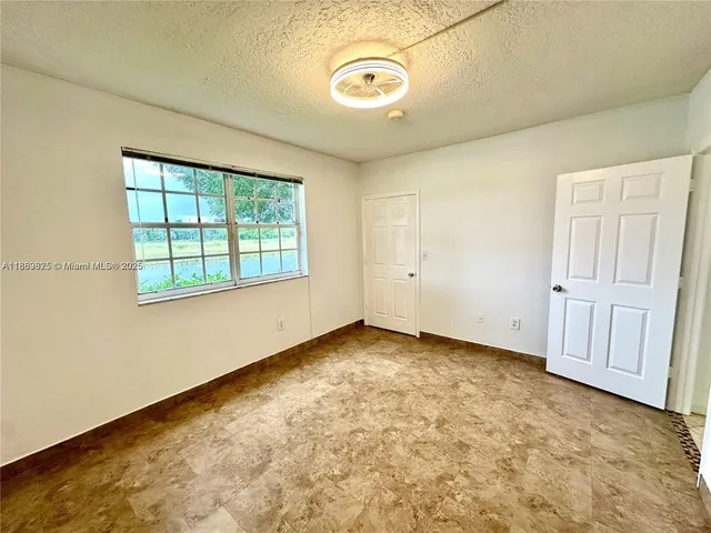 a bedroom with a bed and a tub