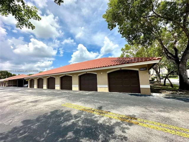 a view of a white house with a outdoor space