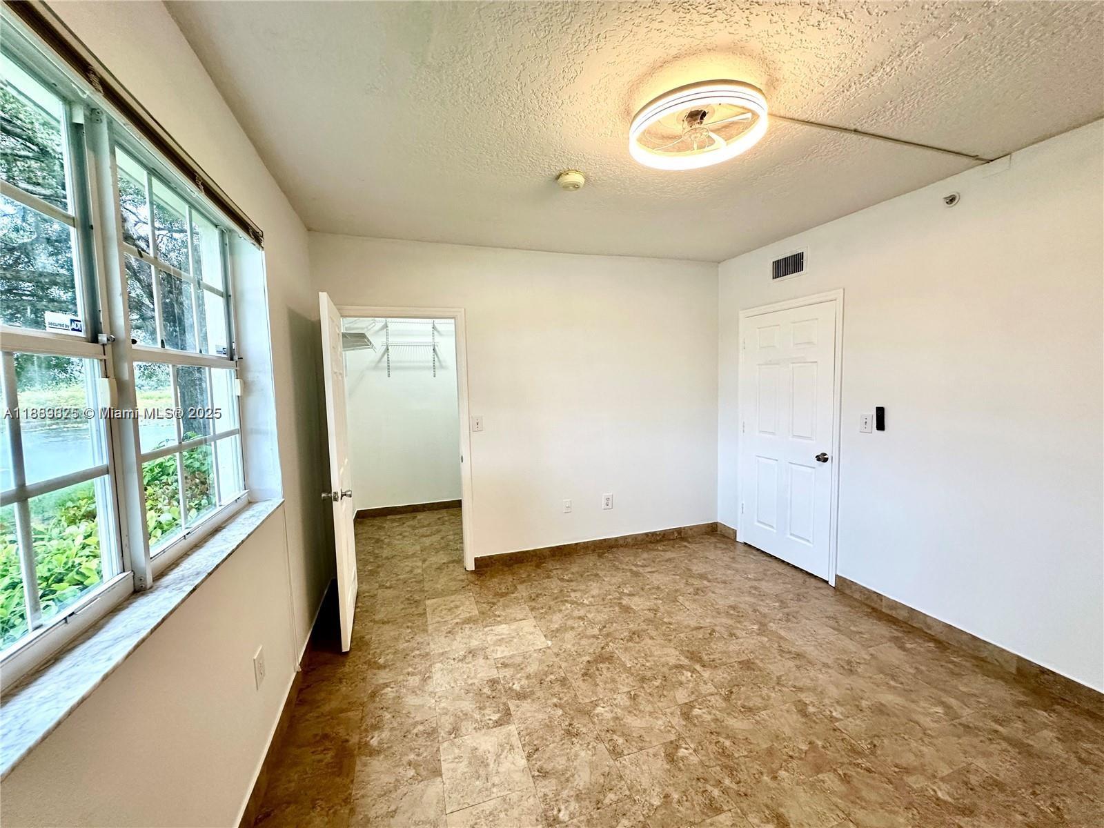 231 Southwest 116th Avenue, Unit 19108 Pembroke Pines, FL 33025 - Photo 32 of 56 a view of a hallway with a large window