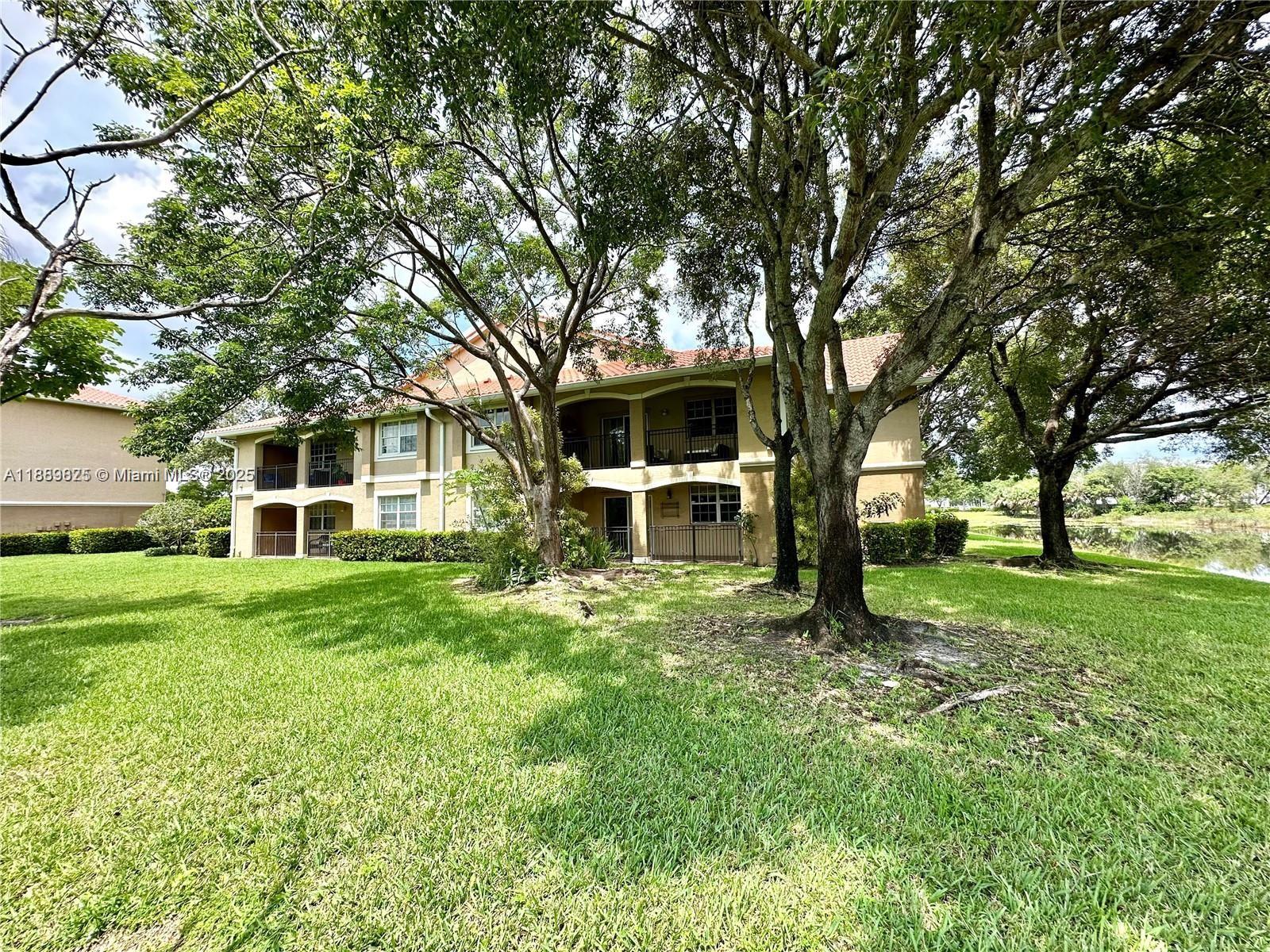 231 Southwest 116th Avenue, Unit 19108 Pembroke Pines, FL 33025 - Photo 34 of 56 front view of a house with a yard