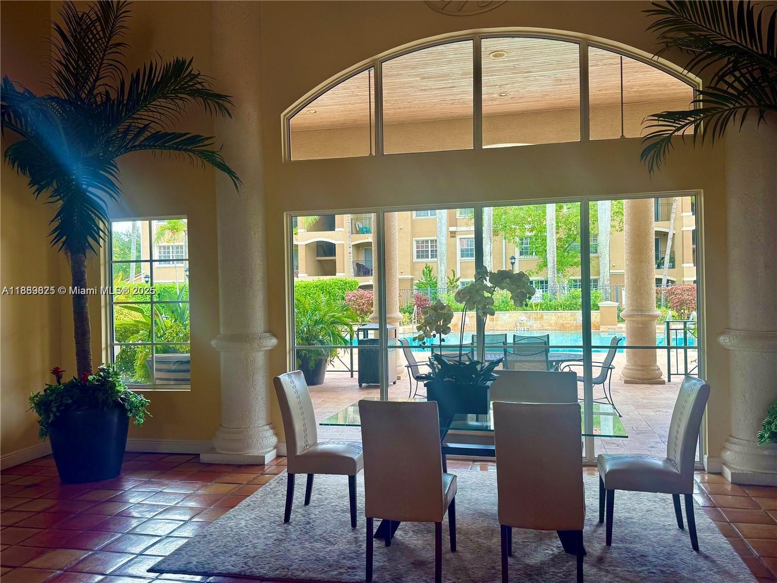 231 Southwest 116th Avenue, Unit 19108 Pembroke Pines, FL 33025 - Photo 41 of 56 a dining room with furniture a chandelier and wooden floor