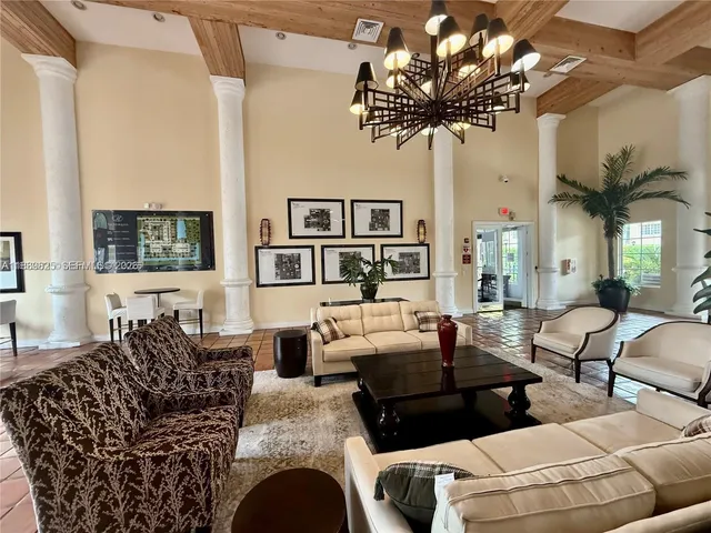 a large kitchen with lots of counter and chairs