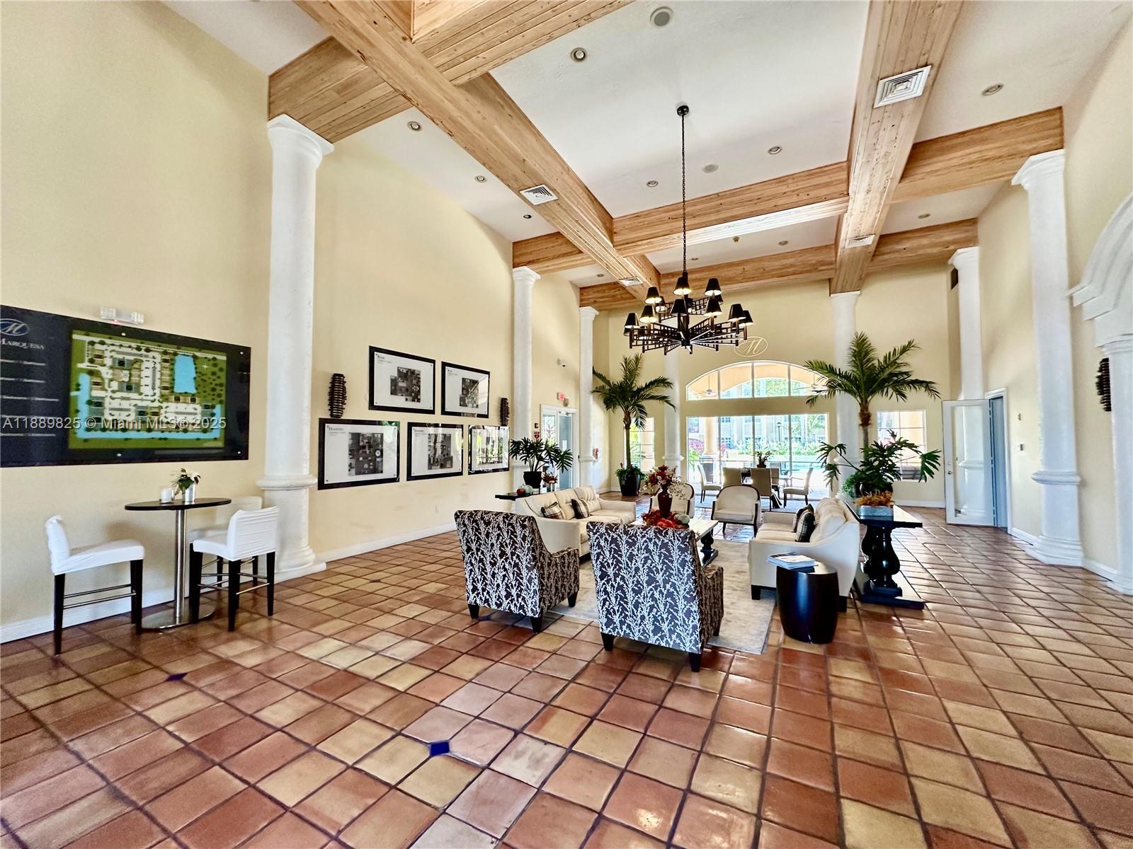 231 Southwest 116th Avenue, Unit 19108 Pembroke Pines, FL 33025 - Photo 43 of 56 a living room with lots of furniture and a chandelier