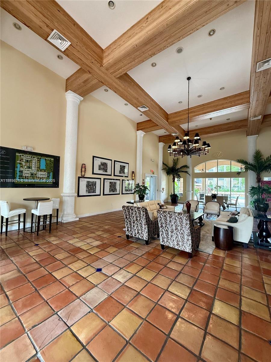 231 Southwest 116th Avenue, Unit 19108 Pembroke Pines, FL 33025 - Photo 44 of 56 a living room with lots of furniture and a chandelier
