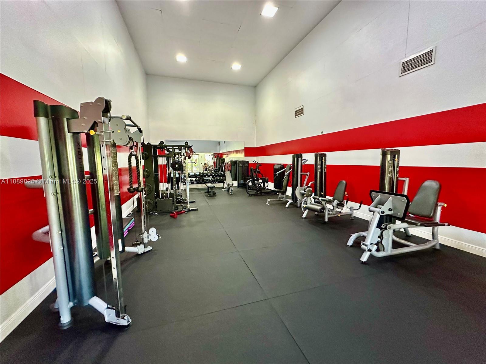 231 Southwest 116th Avenue, Unit 19108 Pembroke Pines, FL 33025 - Photo 48 of 56 a view of a room with gym equipment