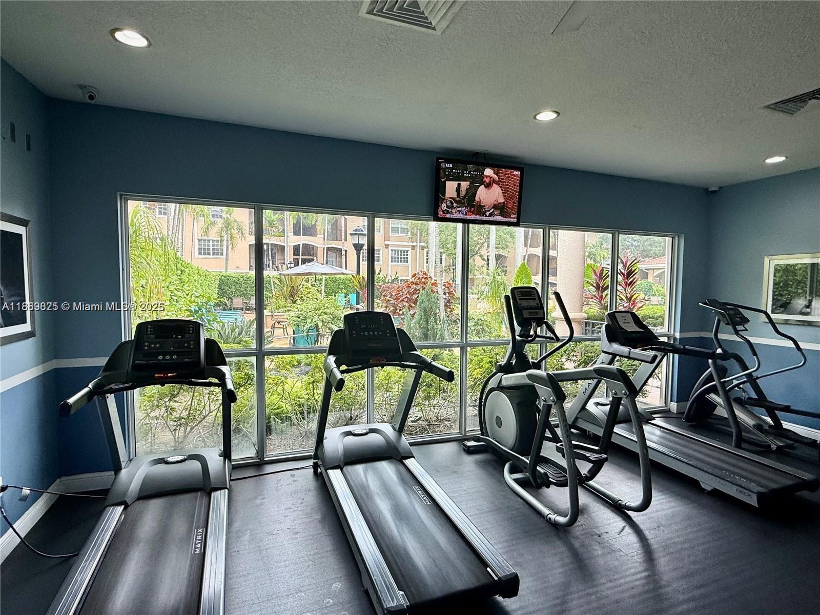 231 Southwest 116th Avenue, Unit 19108 Pembroke Pines, FL 33025 - Photo 49 of 56 a view of a room with gym equipment