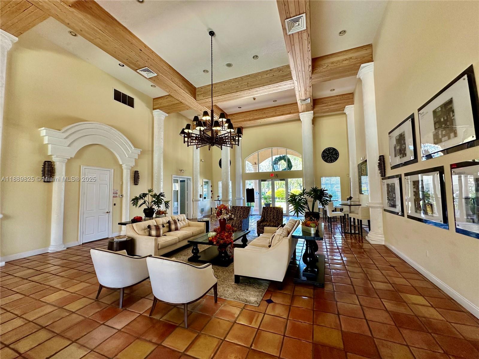 231 Southwest 116th Avenue, Unit 19108 Pembroke Pines, FL 33025 - Photo 52 of 56 a living room with fireplace furniture and a chandelier