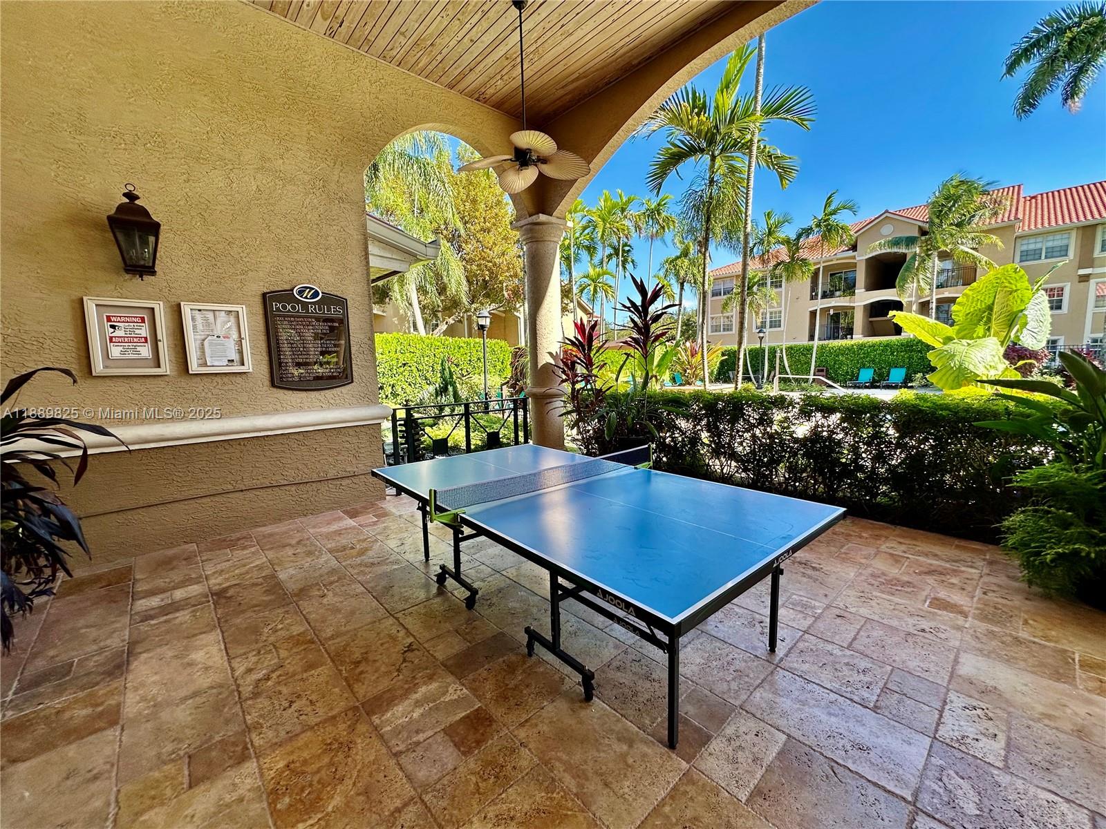 231 Southwest 116th Avenue, Unit 19108 Pembroke Pines, FL 33025 - Photo 54 of 56 a view of a chairs and table in a backyard