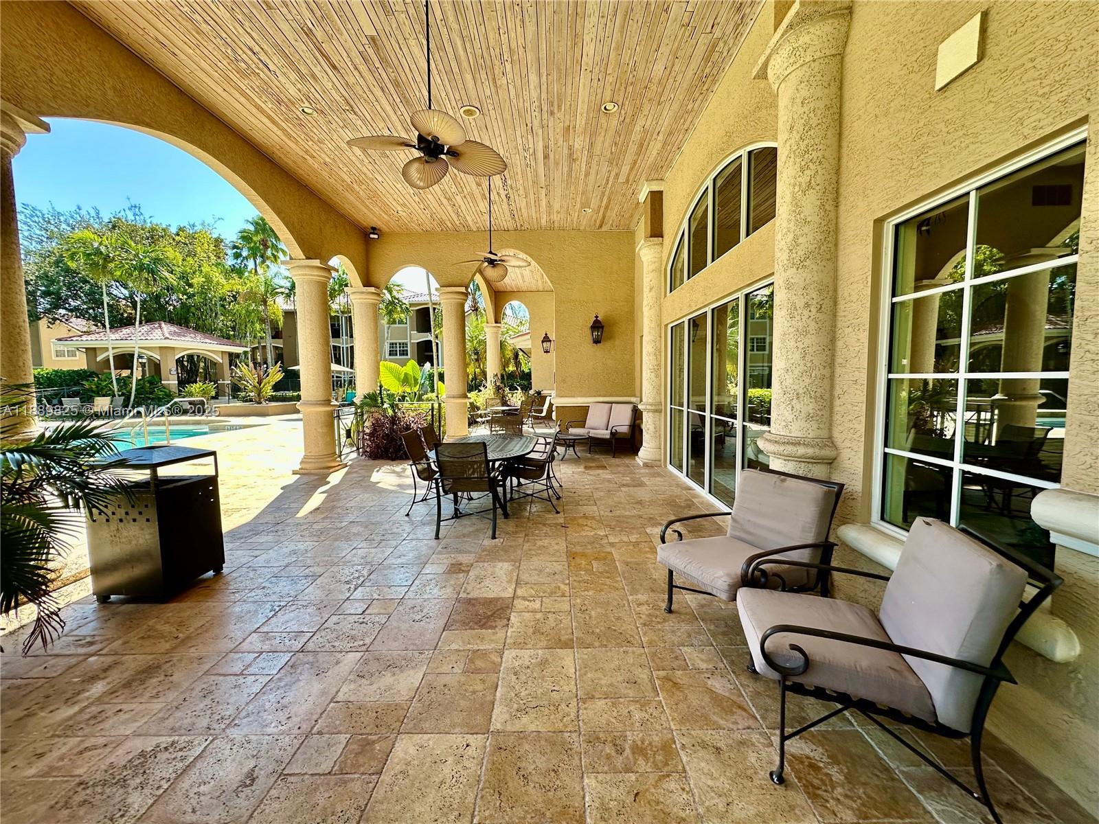 231 Southwest 116th Avenue, Unit 19108 Pembroke Pines, FL 33025 - Photo 55 of 56 a living room with patio furniture and a fireplace