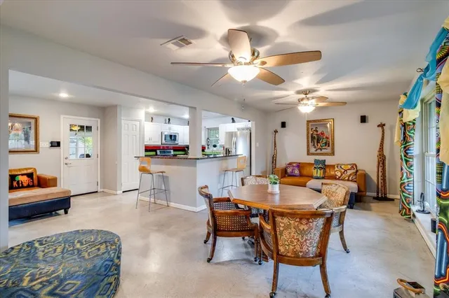 a dining room with furniture and a chandelier