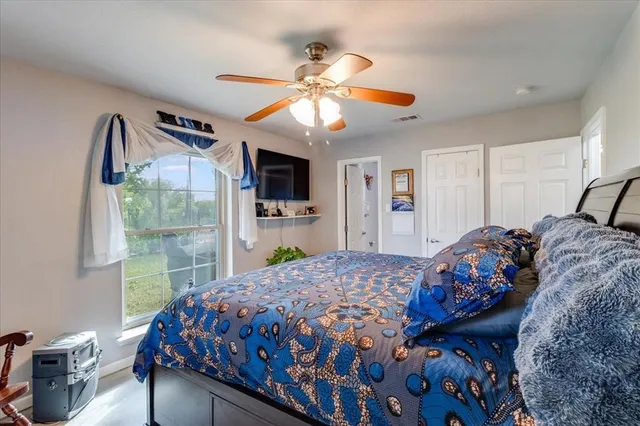 a bedroom with a bed and a chandelier