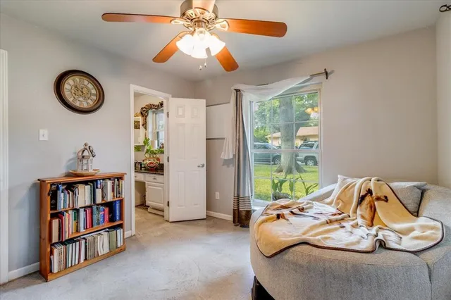 a room with a book shelf and a window