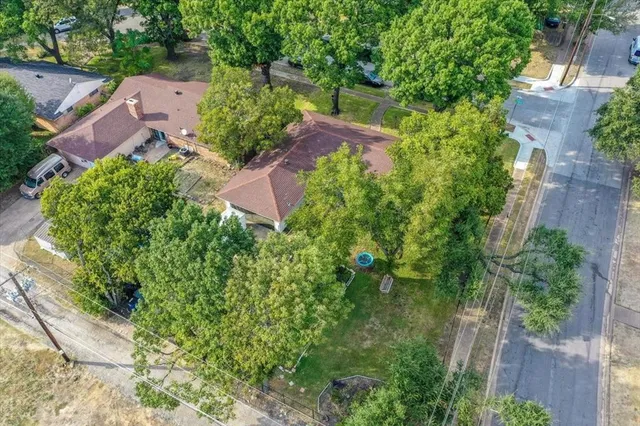 an aerial view of a house with garden space and street view
